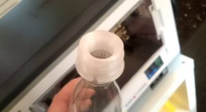 3D printed SLA bottle held in front of 3D printer