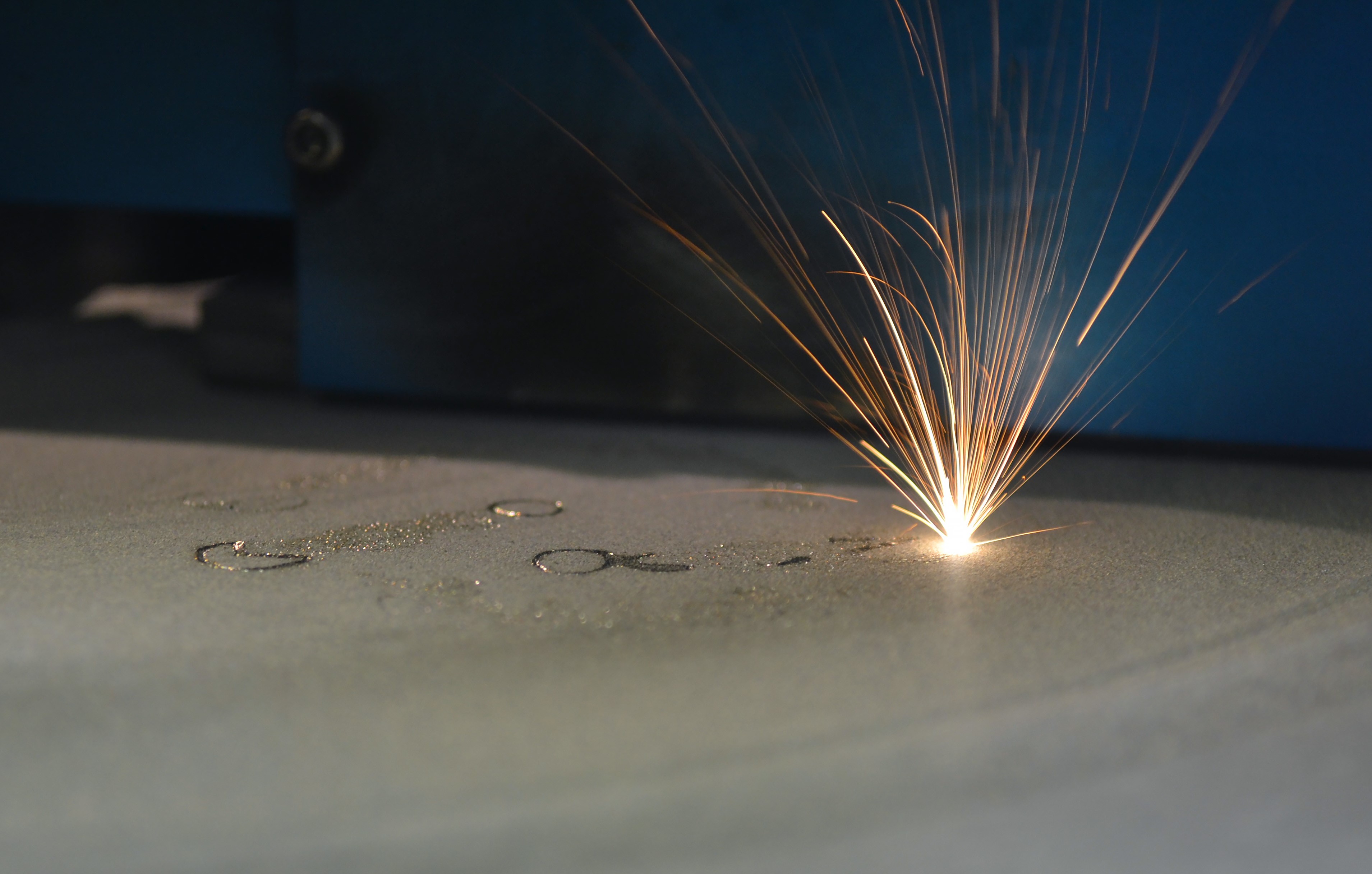 sparks from 3D printer with laser on a powder bed.
