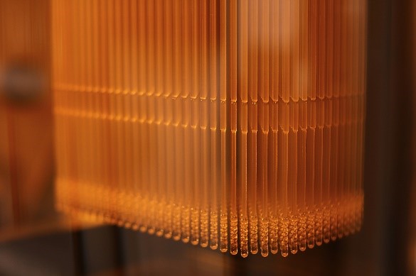 Orange Resin 3D printed nasal swabs on 3D printer.