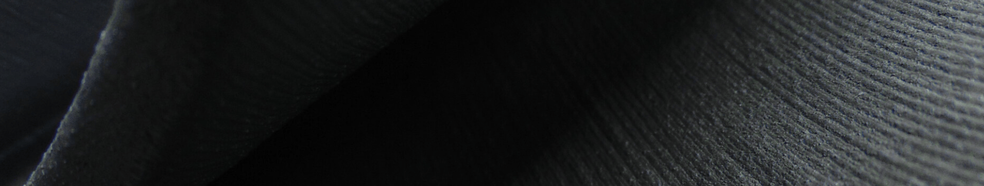 black tinted image of a textured material that is curving